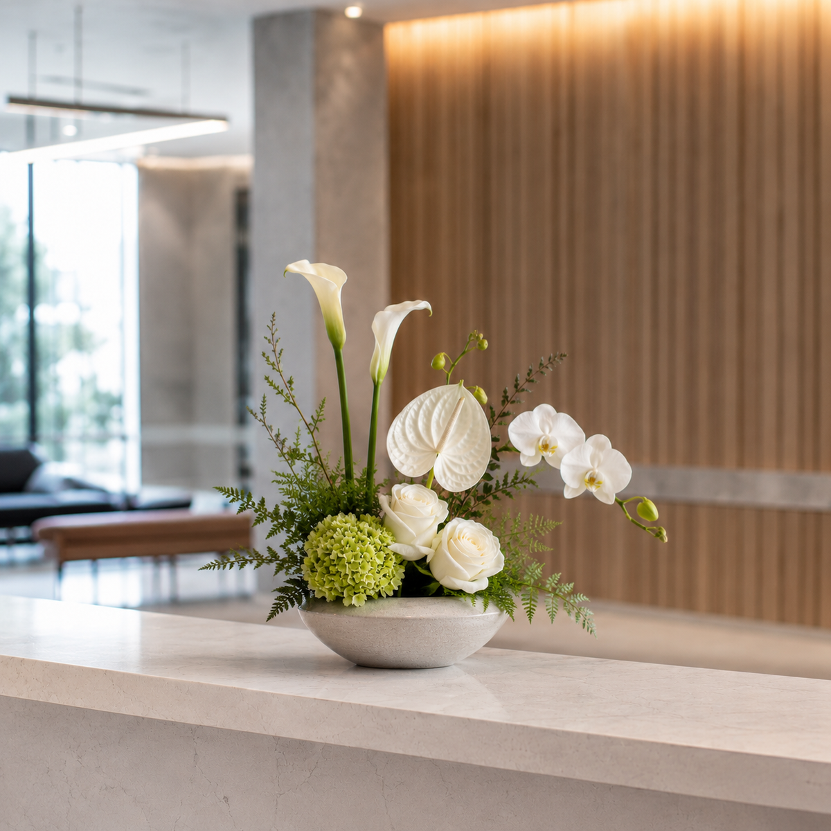 Nordic reception flower arrangement with seasonal flowers, greenery and a minimalist vase for a modern business space in Denmark