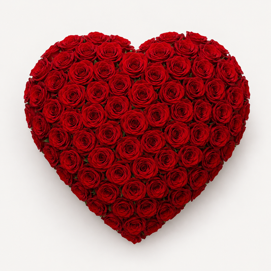 A heart-shaped bouquet made entirely of deep red roses, photographed from directly above on a clean white background.