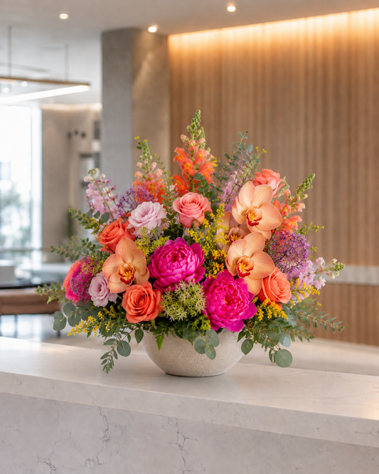 Luxury reception flower arrangement with premium seasonal flowers and an elegant vase for a professional business space in Denmark