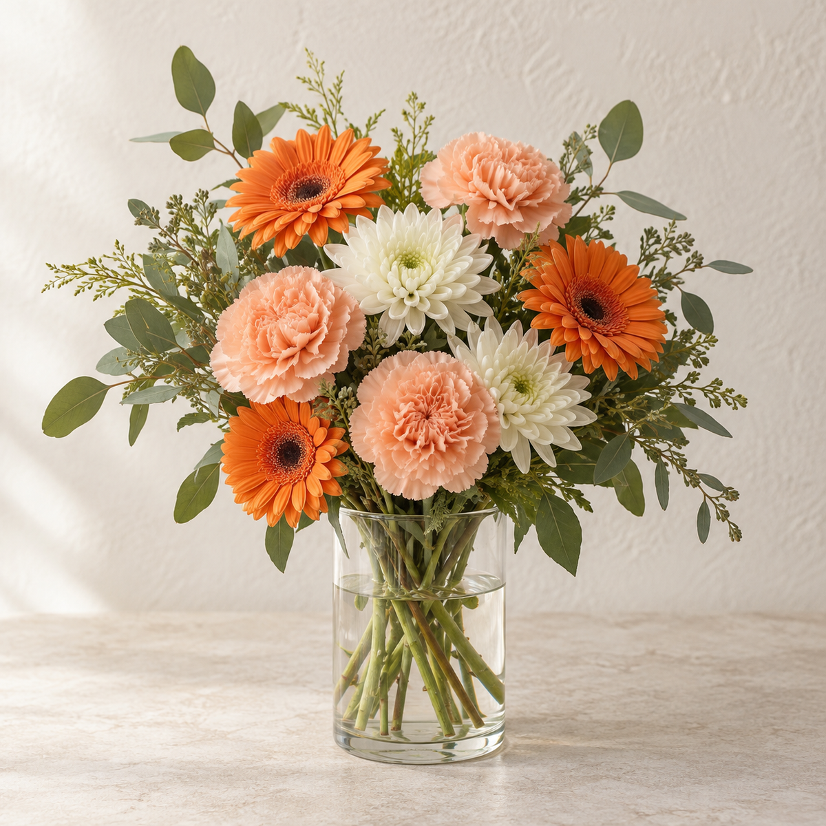 Autumn Glow in a Glass Vase — illustrative design; seasonal flowers may vary